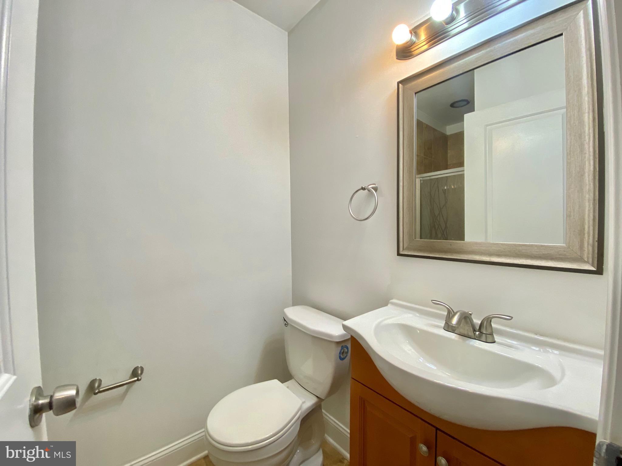 1419 North 17th Street, Unit C Philadelphia, PA 19121 - Photo 20 of 21 a bathroom with a sink a toilet and mirror