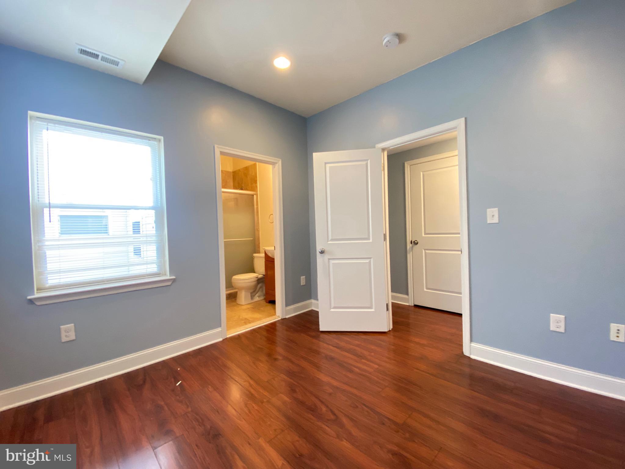 1419 North 17th Street, Unit C Philadelphia, PA 19121 - Photo 3 of 21 a view of an empty room with wooden floor and a window