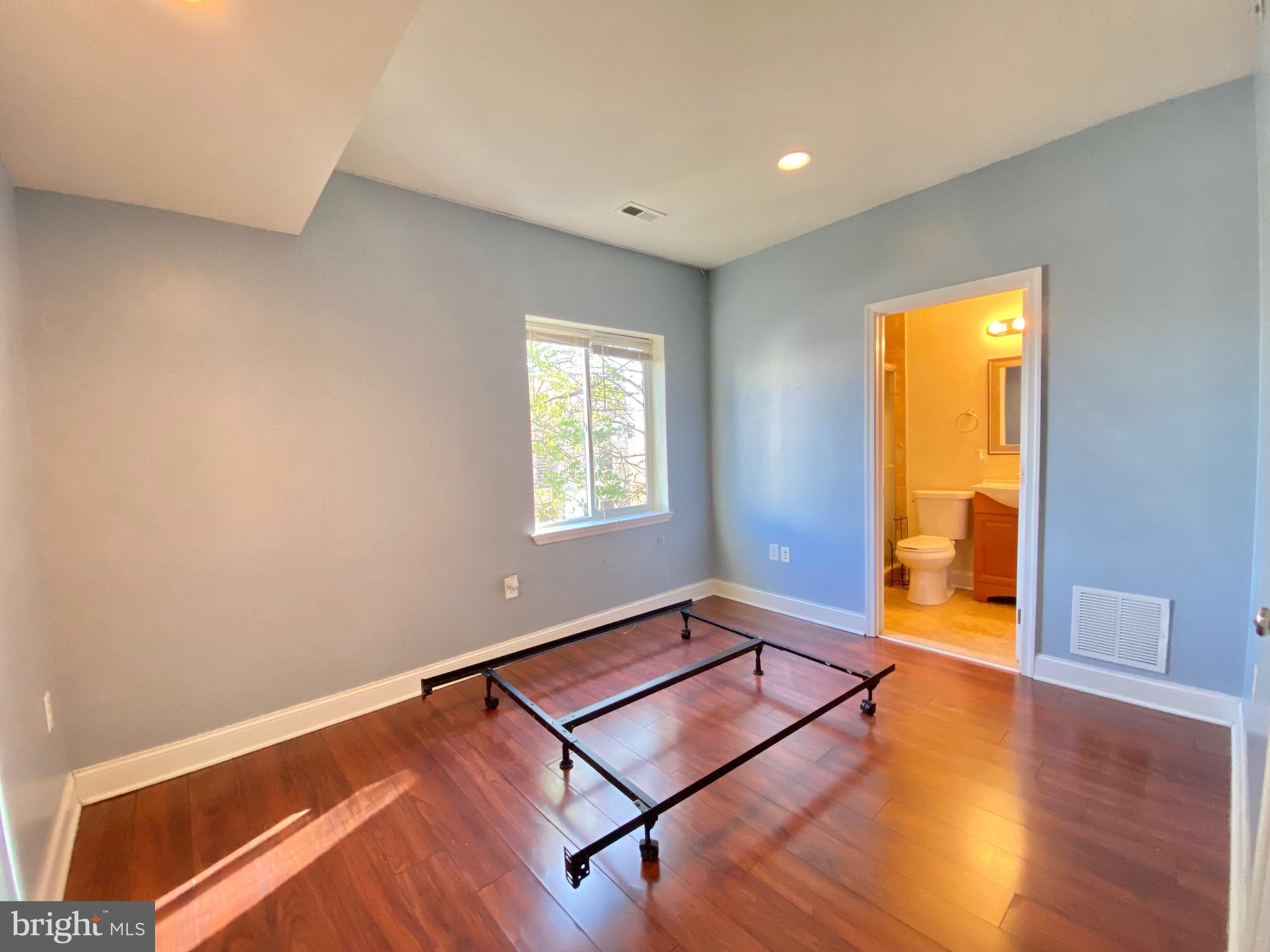 1419 North 17th Street, Unit C Philadelphia, PA 19121 - Photo 6 of 21 a room with windows and wooden floor