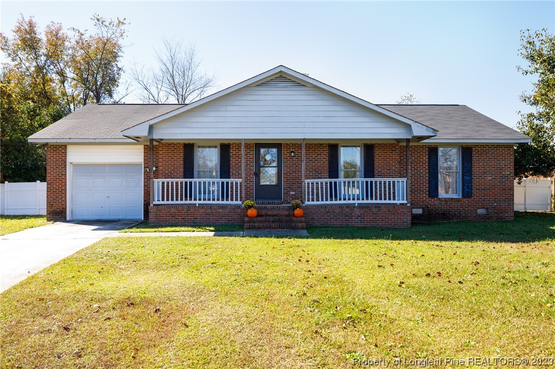 6537 Grist Mill Road Fayetteville, NC 28314 - Photo 1 of 26 a front view of house with yard and garage