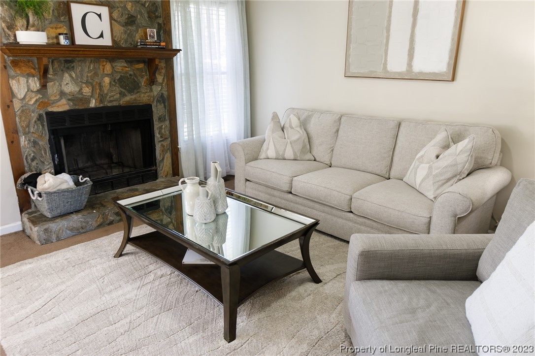 6537 Grist Mill Road Fayetteville, NC 28314 - Photo 12 of 26 a living room with furniture a fireplace and a table