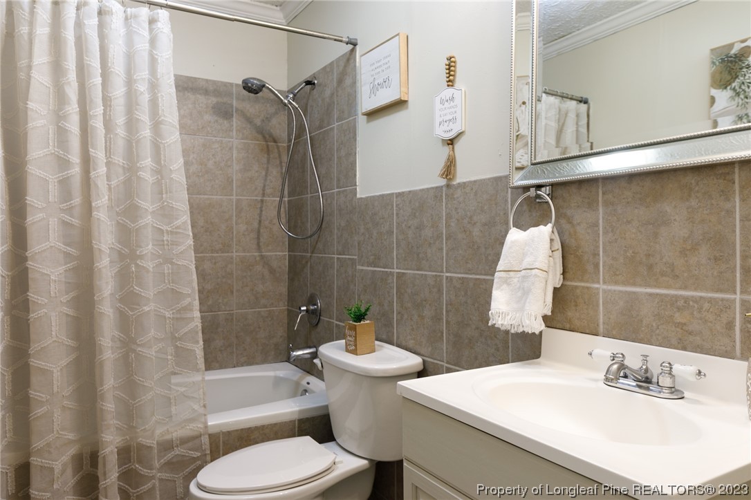 6537 Grist Mill Road Fayetteville, NC 28314 - Photo 15 of 26 a bathroom with a sink toilet and shower