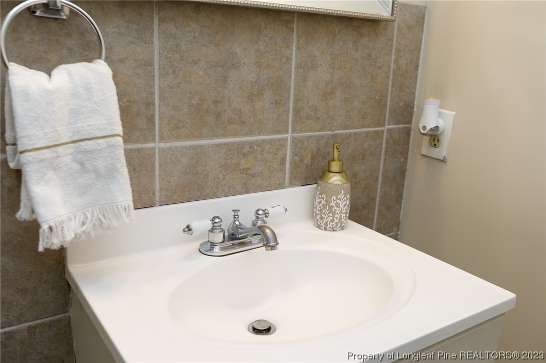 6537 Grist Mill Road Fayetteville, NC 28314 - Photo 16 of 26 a bathroom with a sink and a mirror