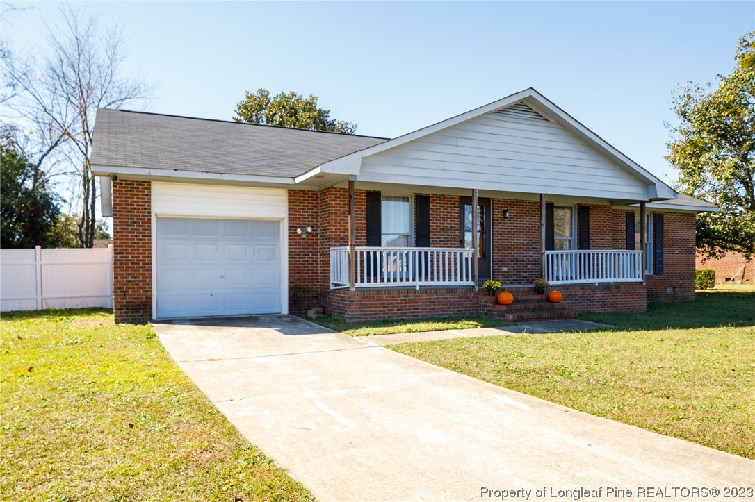 6537 Grist Mill Road Fayetteville, NC 28314 - Photo 2 of 26 a front view of house with yard and garage