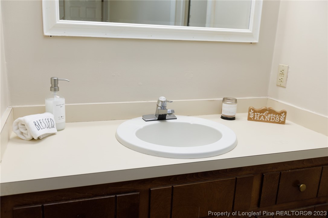 6537 Grist Mill Road Fayetteville, NC 28314 - Photo 21 of 26 a bathroom with a sink and a mirror