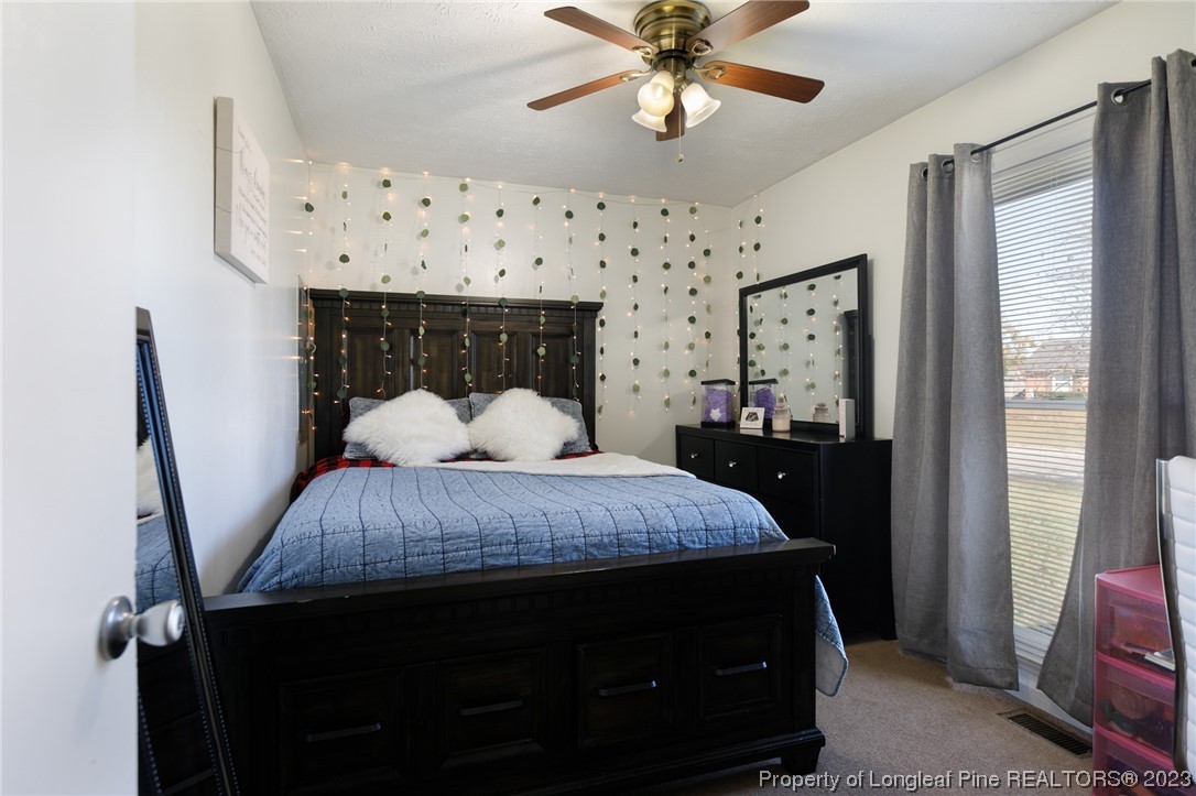 6537 Grist Mill Road Fayetteville, NC 28314 - Photo 23 of 26 a bed sitting in a bedroom next to a window