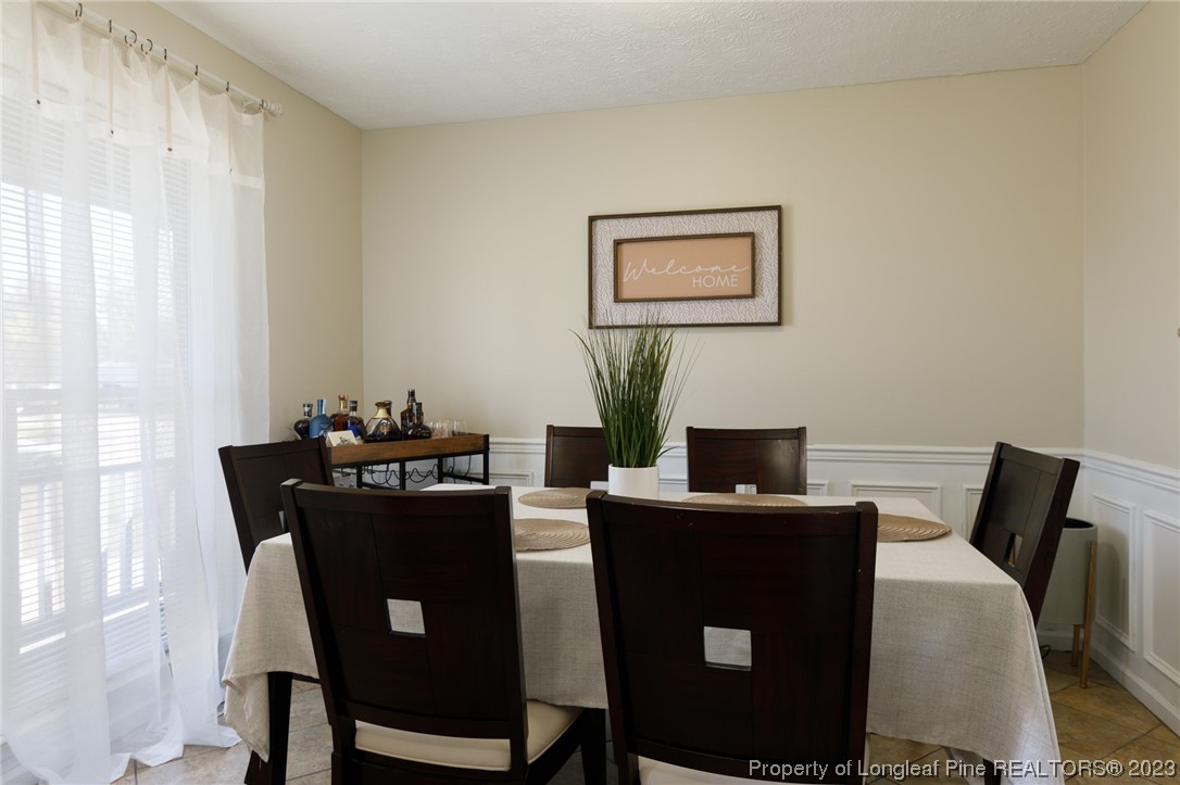 6537 Grist Mill Road Fayetteville, NC 28314 - Photo 5 of 26 a view of a dining room with furniture and wooden floor