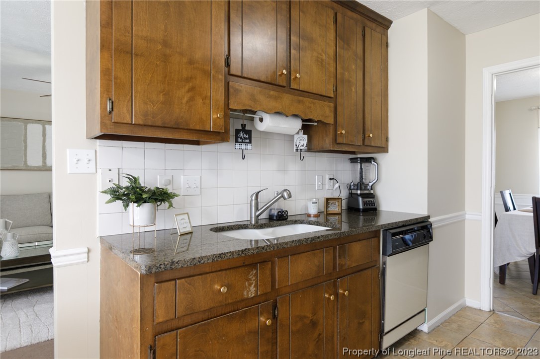 6537 Grist Mill Road Fayetteville, NC 28314 - Photo 8 of 26 a kitchen with stainless steel appliances granite countertop a sink a stove and cabinets