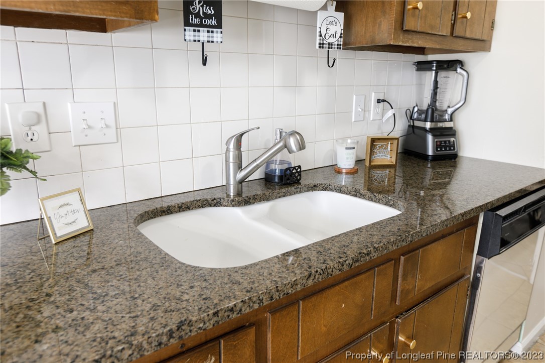 6537 Grist Mill Road Fayetteville, NC 28314 - Photo 9 of 26 a bathroom with a granite countertop sink a mirror and vanity
