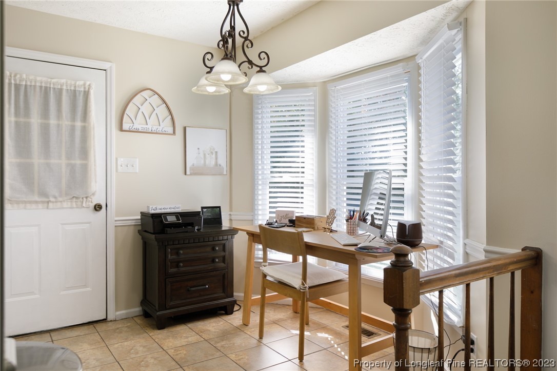 6537 Grist Mill Road Fayetteville, NC 28314 - Photo 10 of 26 a view of a dining room with furniture and chandelier