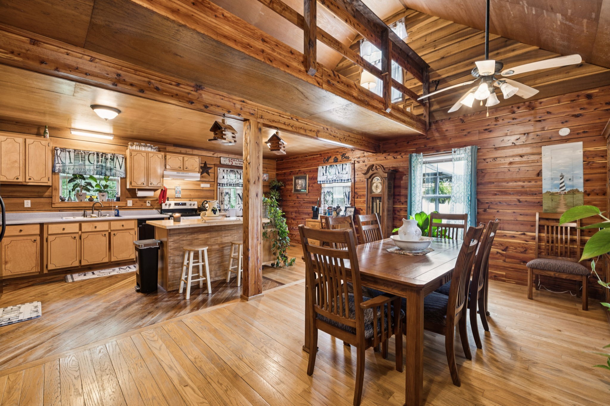 176 Robert Hensley Road Hohenwald, TN 38462 - Photo 12 of 87 a dining room with stainless steel appliances wooden floors a table and chairs