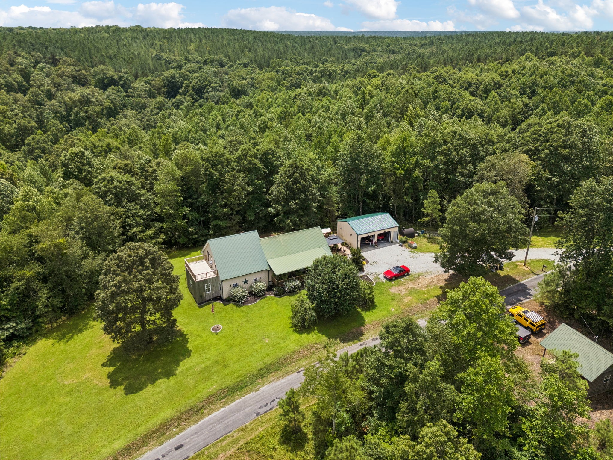 176 Robert Hensley Road Hohenwald, TN 38462 - Photo 4 of 87 a view of a forest with a yard