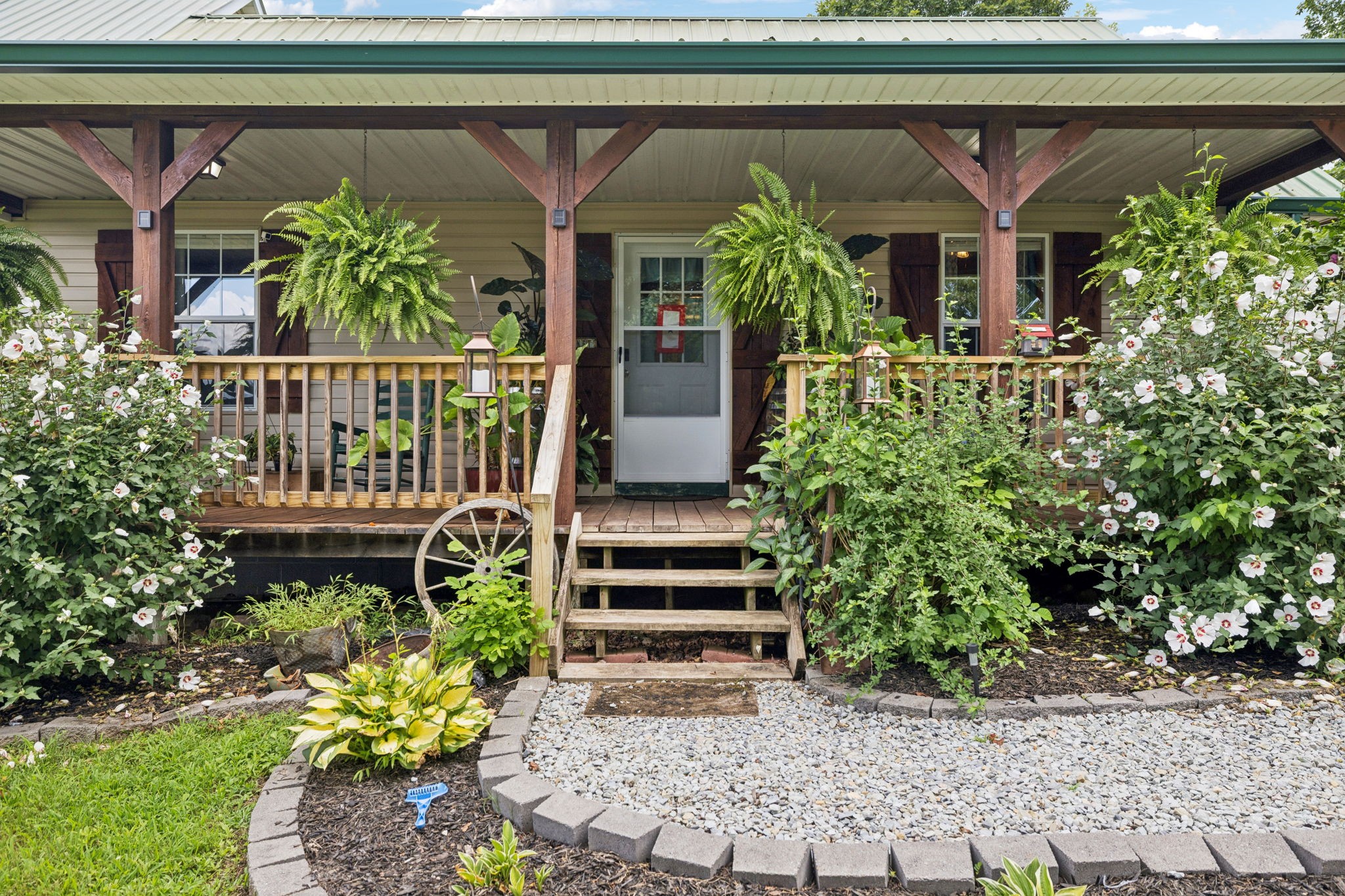 176 Robert Hensley Road Hohenwald, TN 38462 - Photo 9 of 87 a front view of a house with a garden