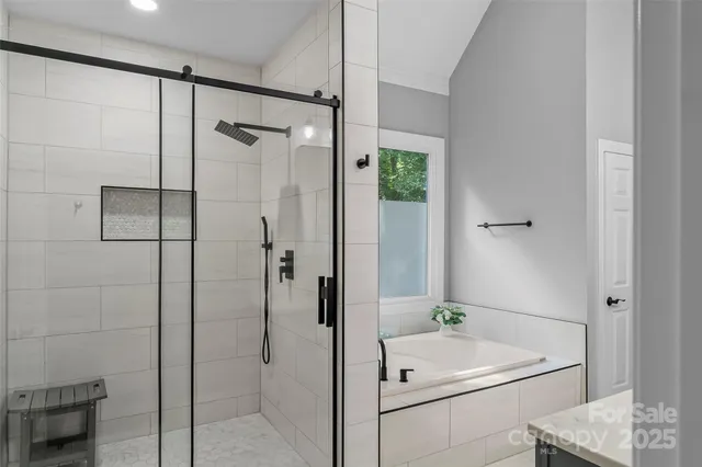 a bathroom with a white bath tub and shower