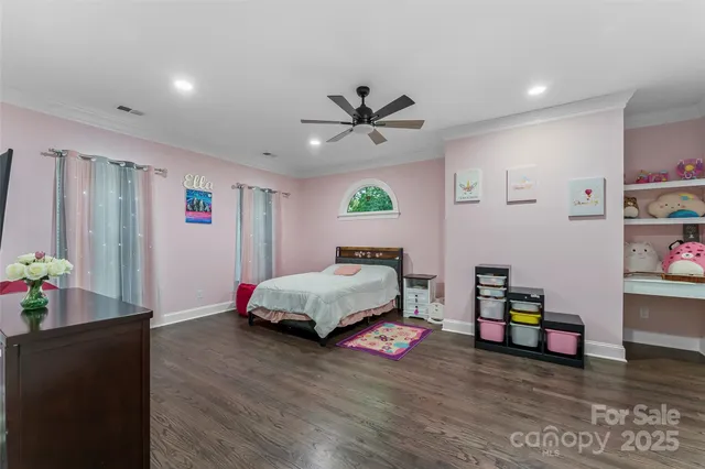a bedroom with bed and a chandelier