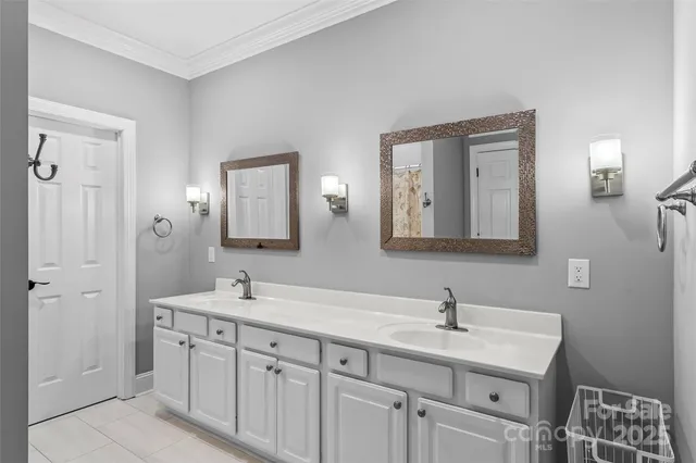 a bathroom with a double vanity sink and a mirror