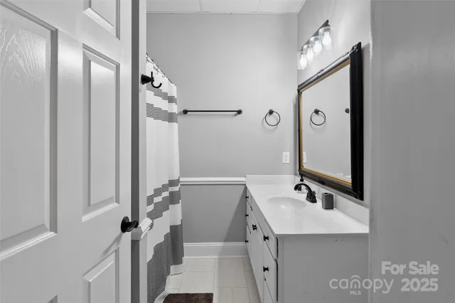 a bathroom with a sink vanity and a mirror