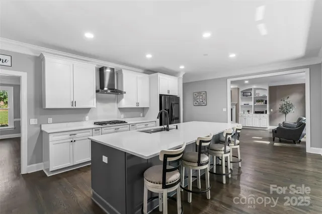 a kitchen with a dining table chairs refrigerator and cabinets