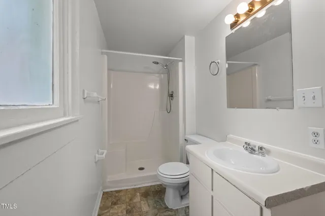 a kitchen with white cabinets and sink