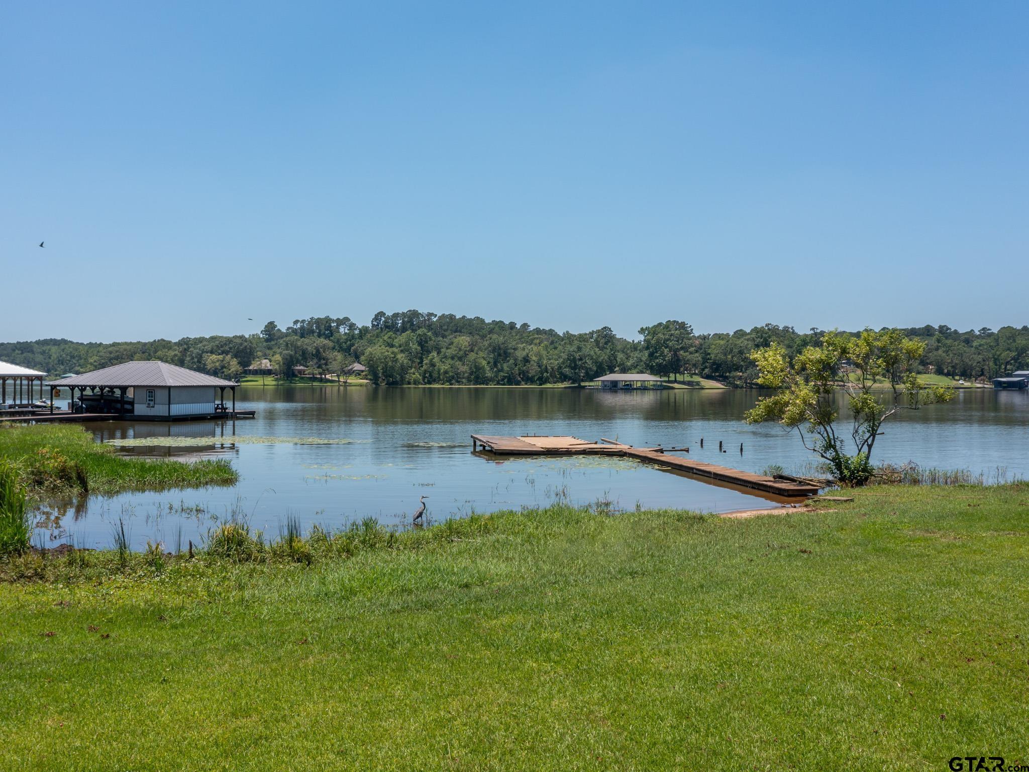 15606 McElroy Road Whitehouse, TX 75791 - Photo 14 of 37 a view of a lake with houses in the back