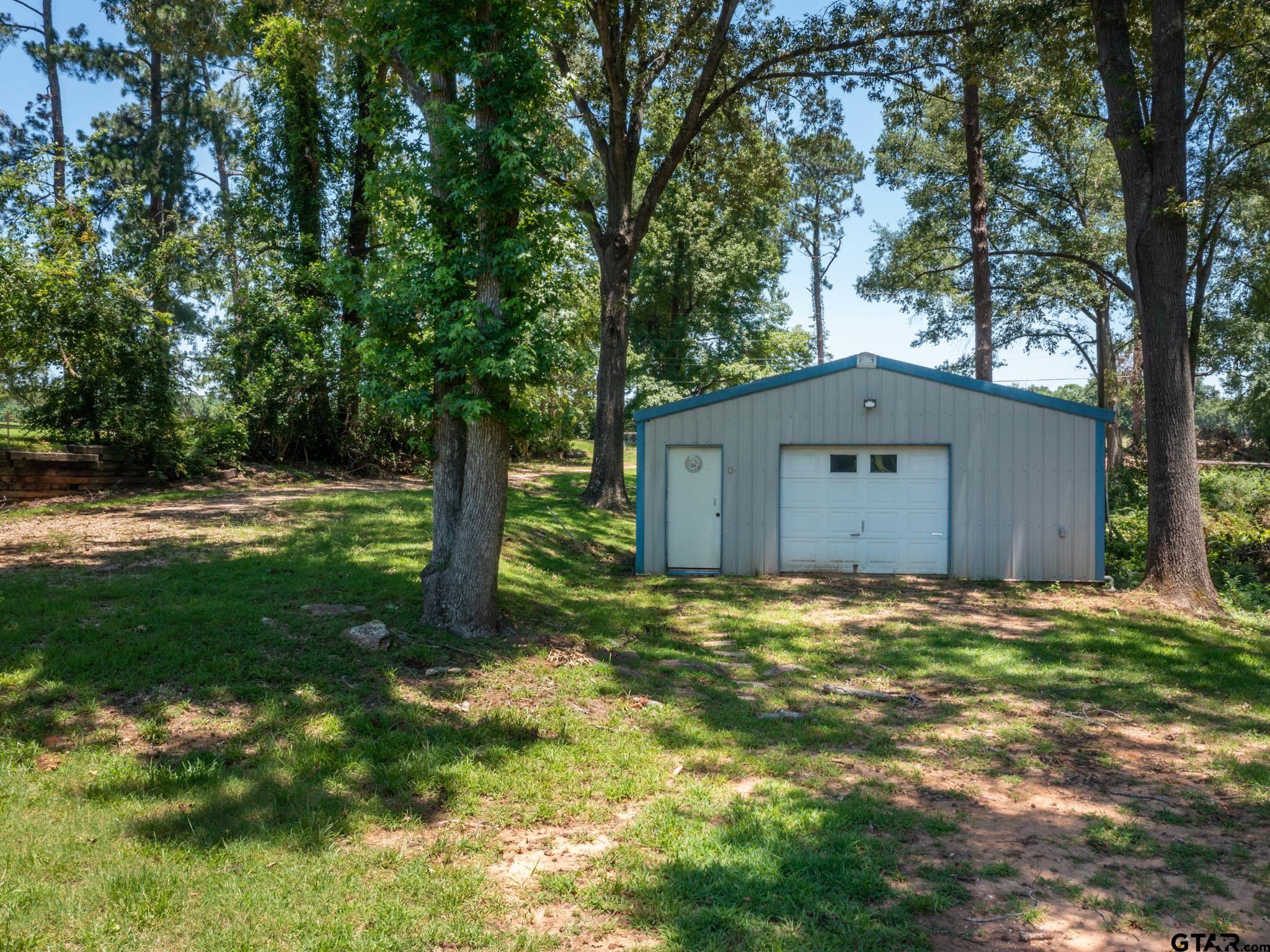 15606 McElroy Road Whitehouse, TX 75791 - Photo 2 of 37 a house is sitting in middle od the grass