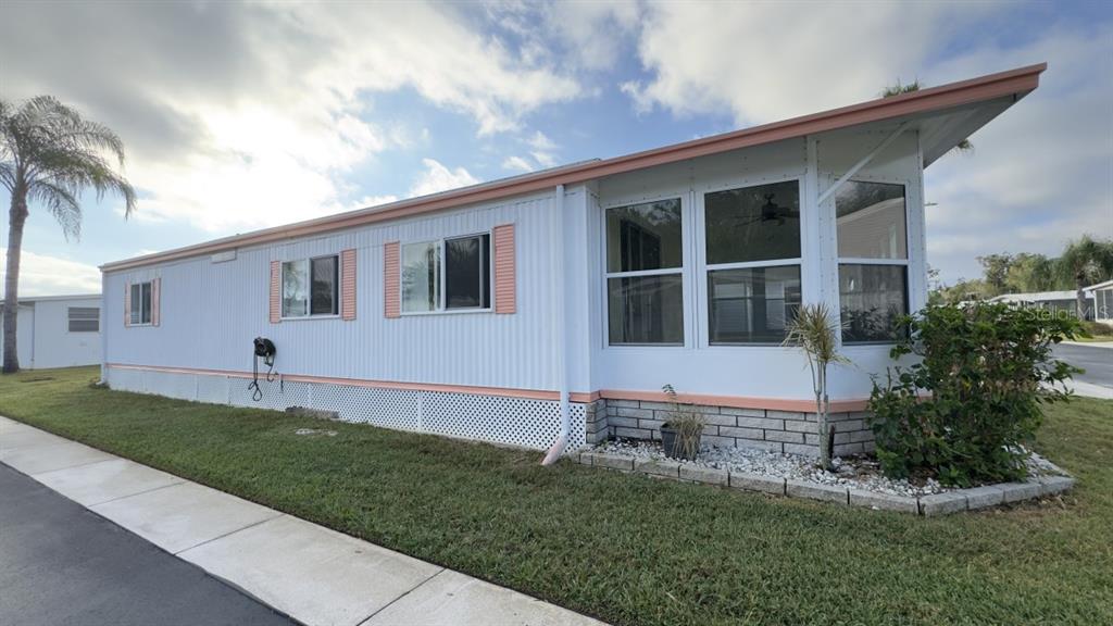 10928 Federal Drive Port Richey, FL 34668 - Photo 2 of 12 a front view of a house with a yard