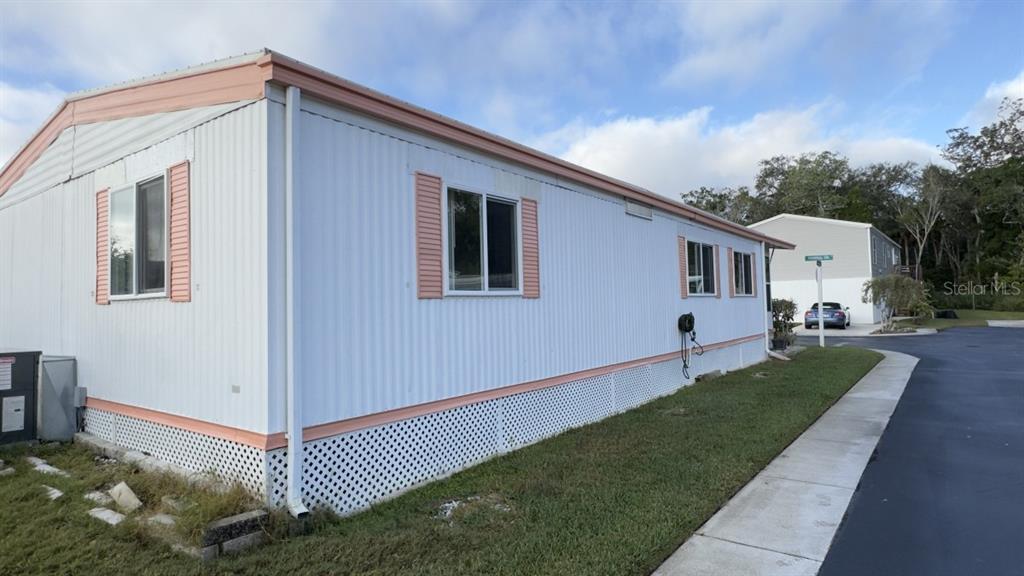 10928 Federal Drive Port Richey, FL 34668 - Photo 3 of 12 a front view of a house with a yard