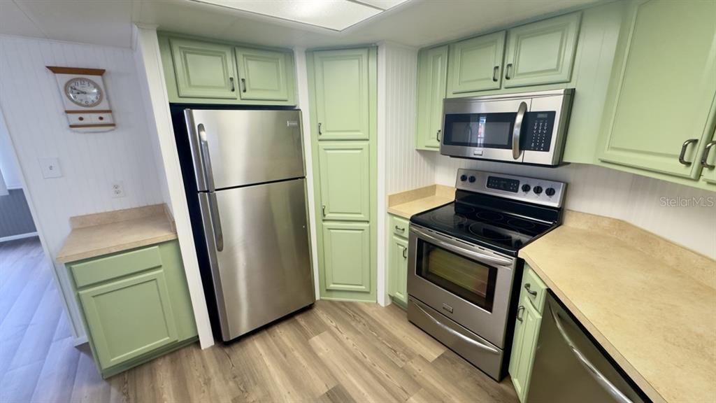 10928 Federal Drive Port Richey, FL 34668 - Photo 7 of 12 a kitchen with a refrigerator stove and microwave