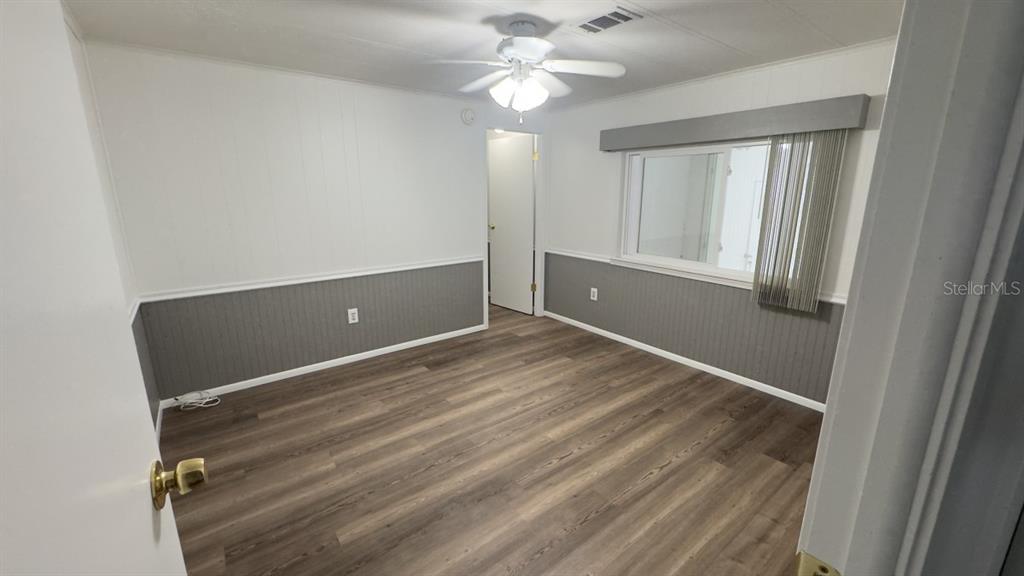10928 Federal Drive Port Richey, FL 34668 - Photo 8 of 12 wooden floor and window in a room