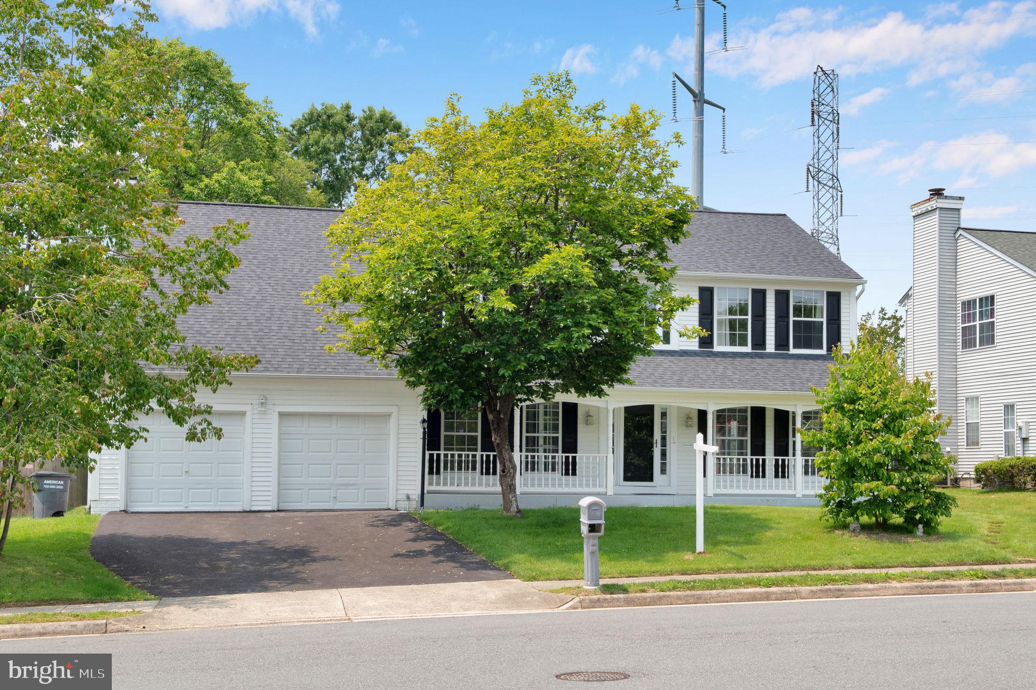 15704 Beau Ridge Drive Woodbridge, VA 22193 - Photo 3 of 26 a front view of a house with garden and trees