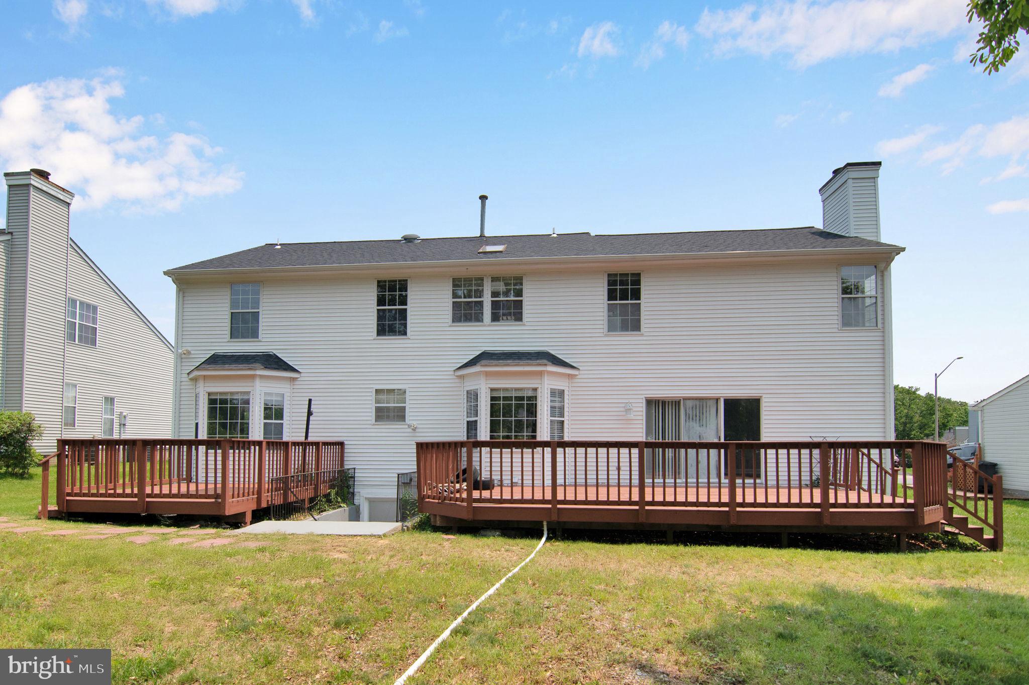 15704 Beau Ridge Drive Woodbridge, VA 22193 - Photo 6 of 26 a front view of a house with a garden and deck