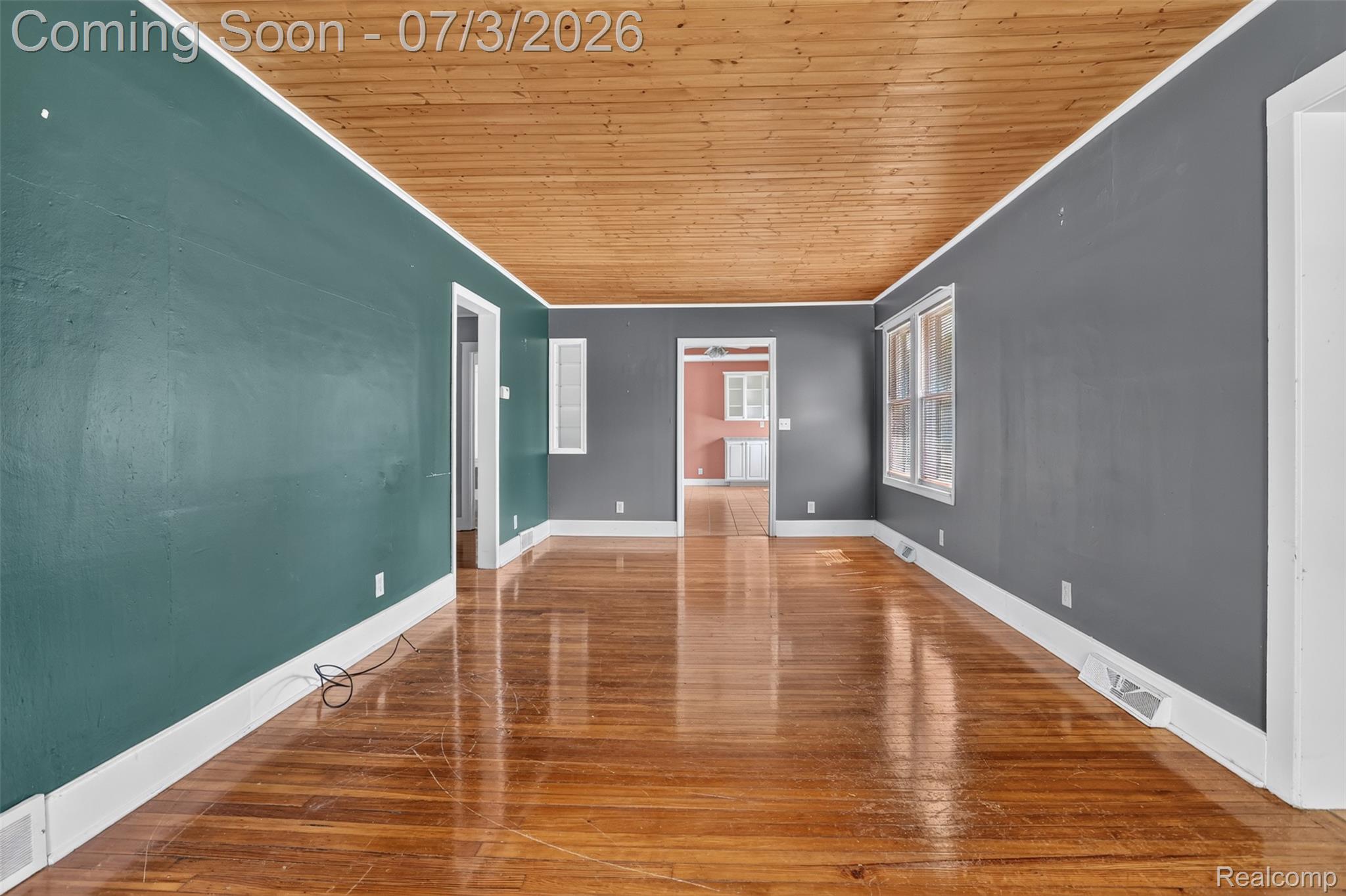 4322 Baker Road Bridgeport, MI 48722 - Photo 8 of 29 Expansive room featuring rich wood-finish flooring and a wood-paneled ceiling