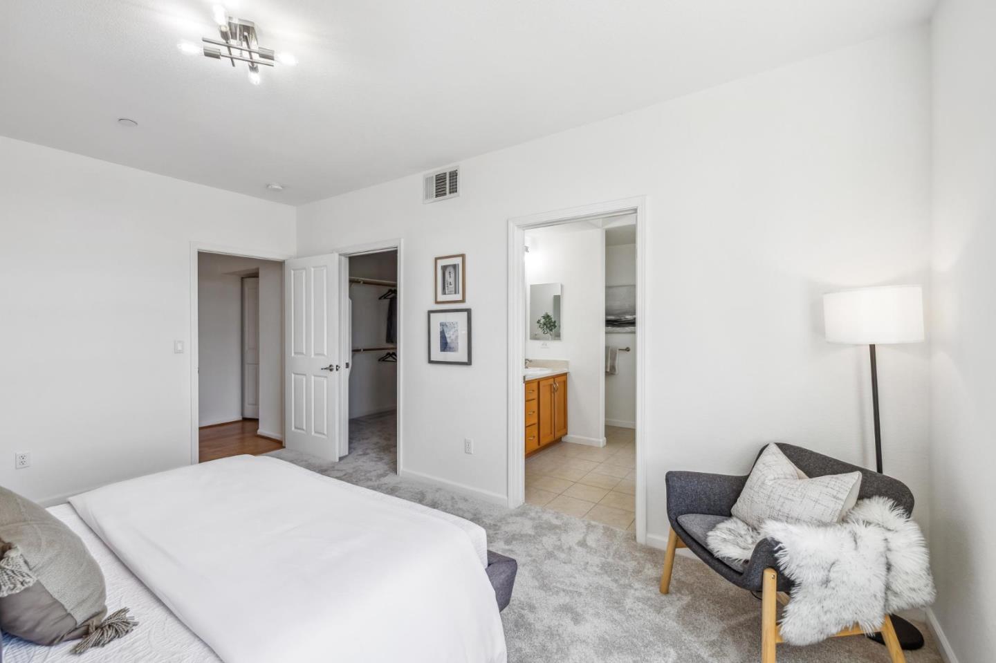 1388 Broadway, Unit 209 Millbrae, CA 94030 - Photo 19 of 40 a bedroom with a bed and a lamp