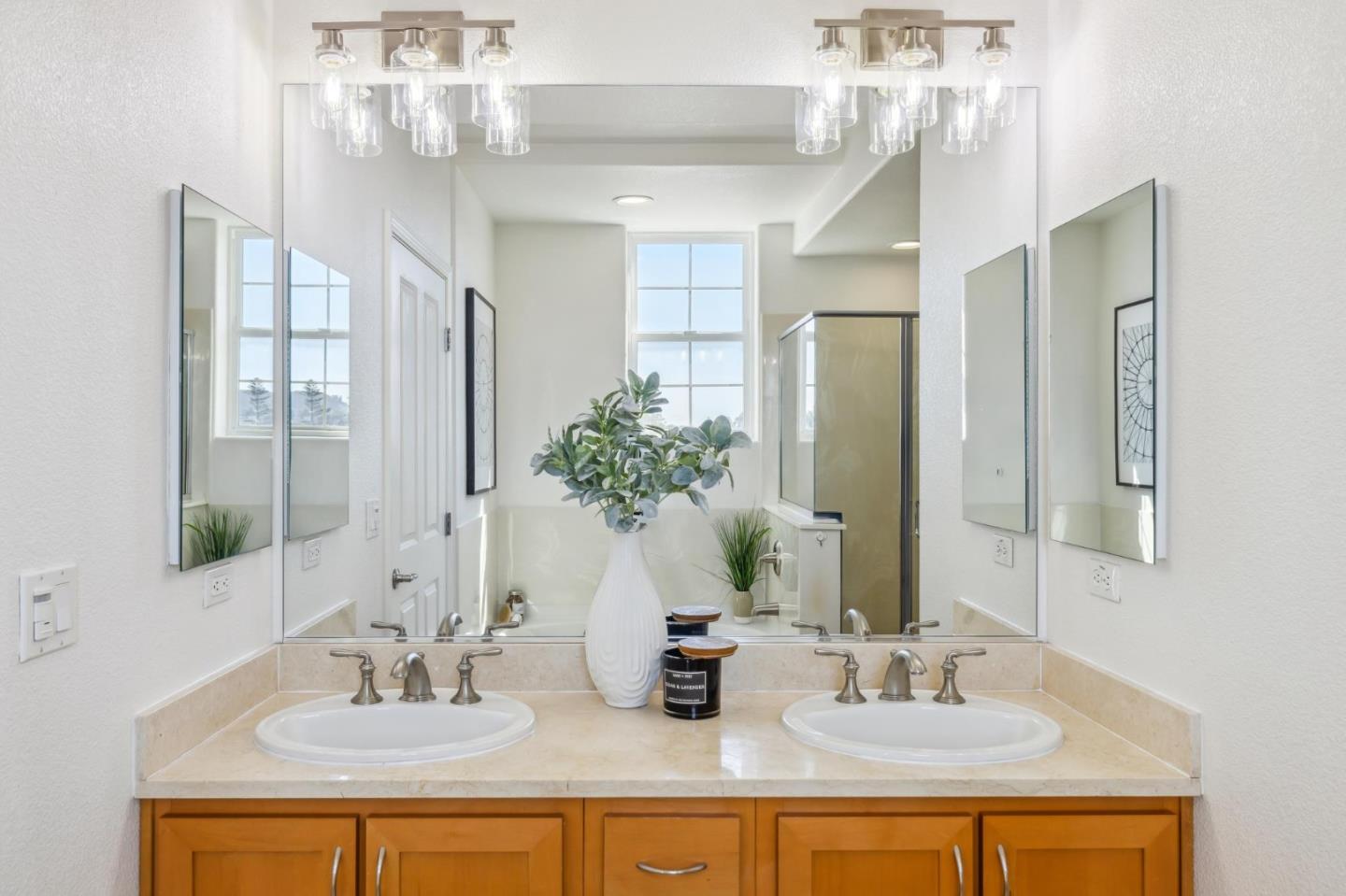 1388 Broadway, Unit 209 Millbrae, CA 94030 - Photo 20 of 40 a bathroom with double vanity sinks a vanity and a mirror