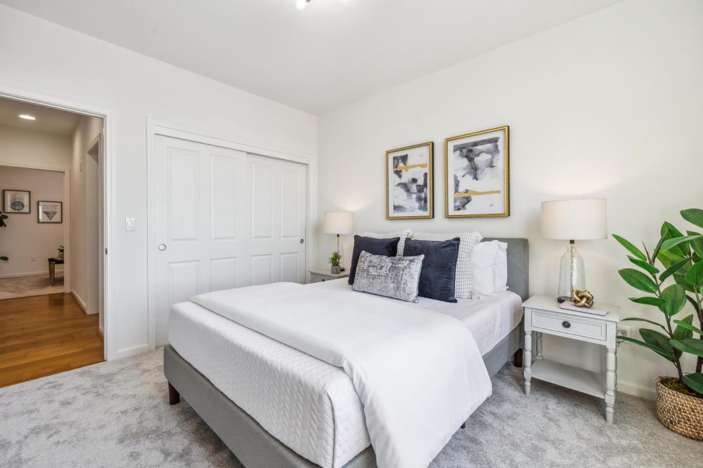 1388 Broadway, Unit 209 Millbrae, CA 94030 - Photo 26 of 40 a bedroom with a bed and a potted plant