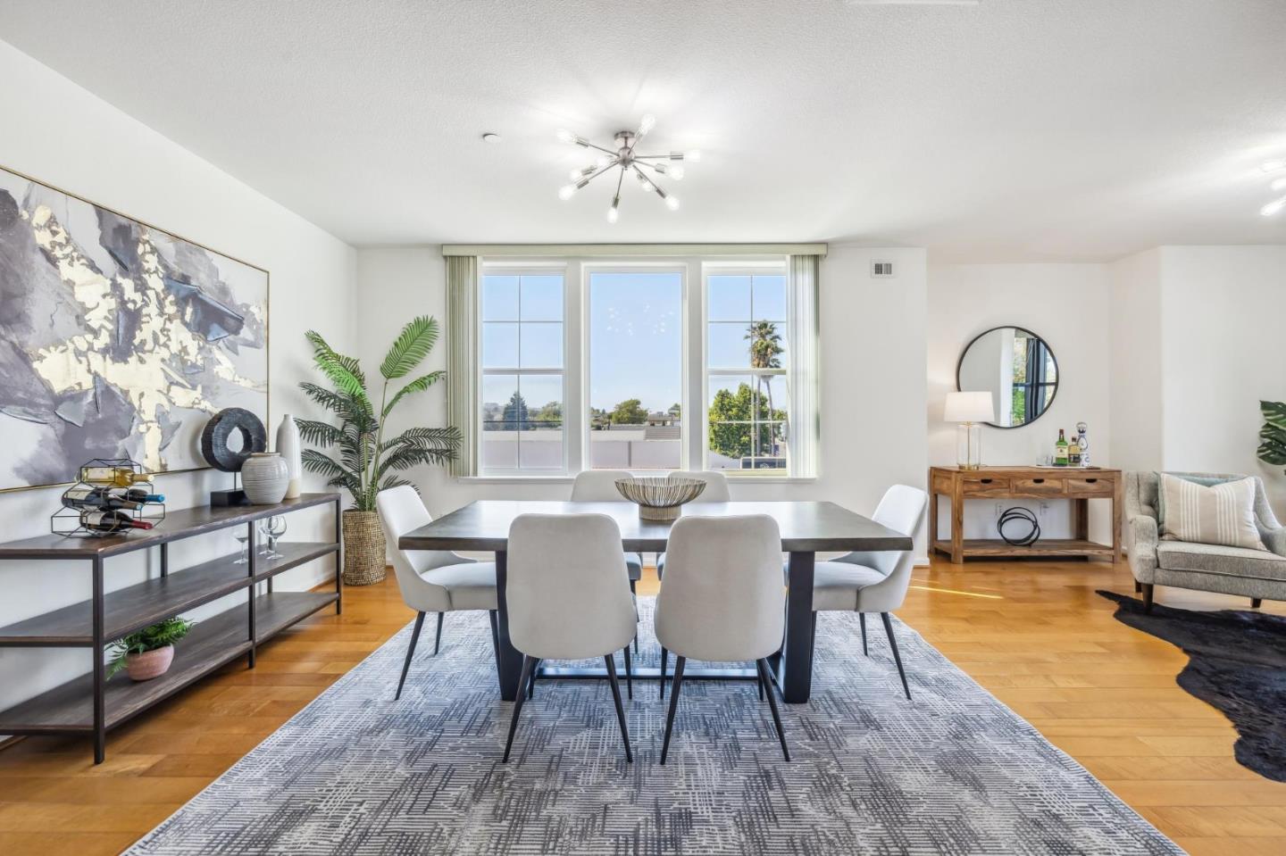 1388 Broadway, Unit 209 Millbrae, CA 94030 - Photo 4 of 40 a view of a dining room with furniture a chandelier and wooden floor