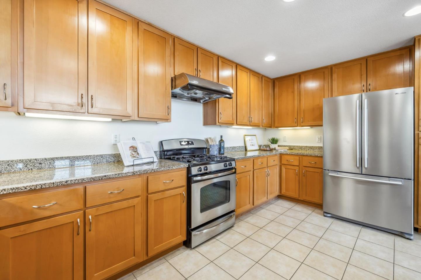 1388 Broadway, Unit 209 Millbrae, CA 94030 - Photo 9 of 40 a kitchen with a refrigerator sink and cabinets