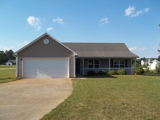 2309 Stroud Road Jackson, GA 30233 - Photo 1 of 1 a front view of a house with a yard and garage