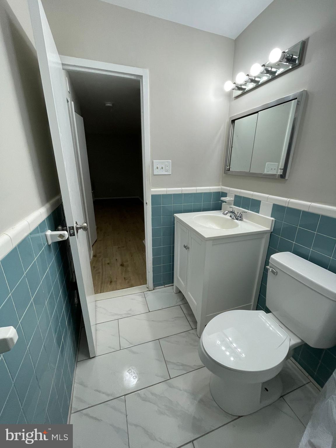 8601 Manchester Road, Unit 217 Silver Spring, MD 20901 - Photo 6 of 8 a bathroom with a toilet a sink and mirror