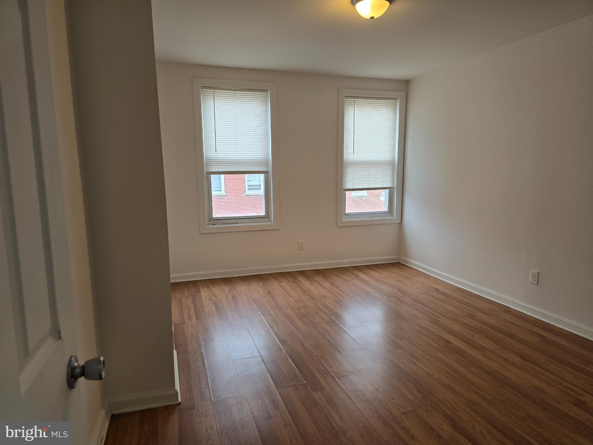 2418 Etting Street Baltimore, MD 21217 - Photo 13 of 24 an empty room with wooden floor and windows