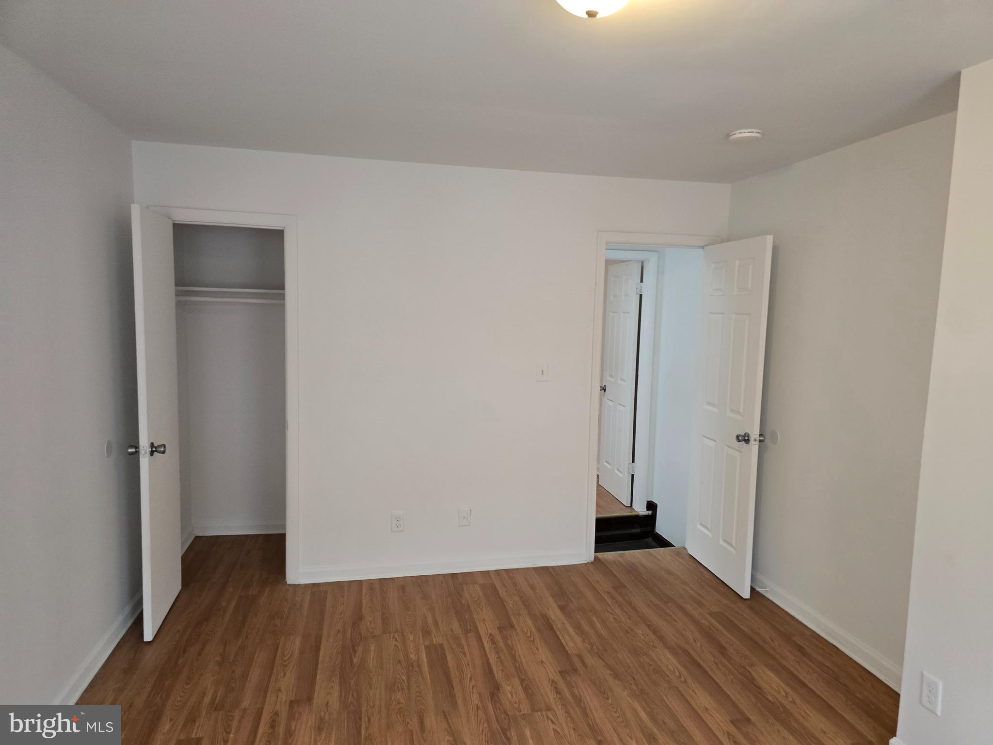 2418 Etting Street Baltimore, MD 21217 - Photo 15 of 24 a view of an empty room with wooden floor and closet