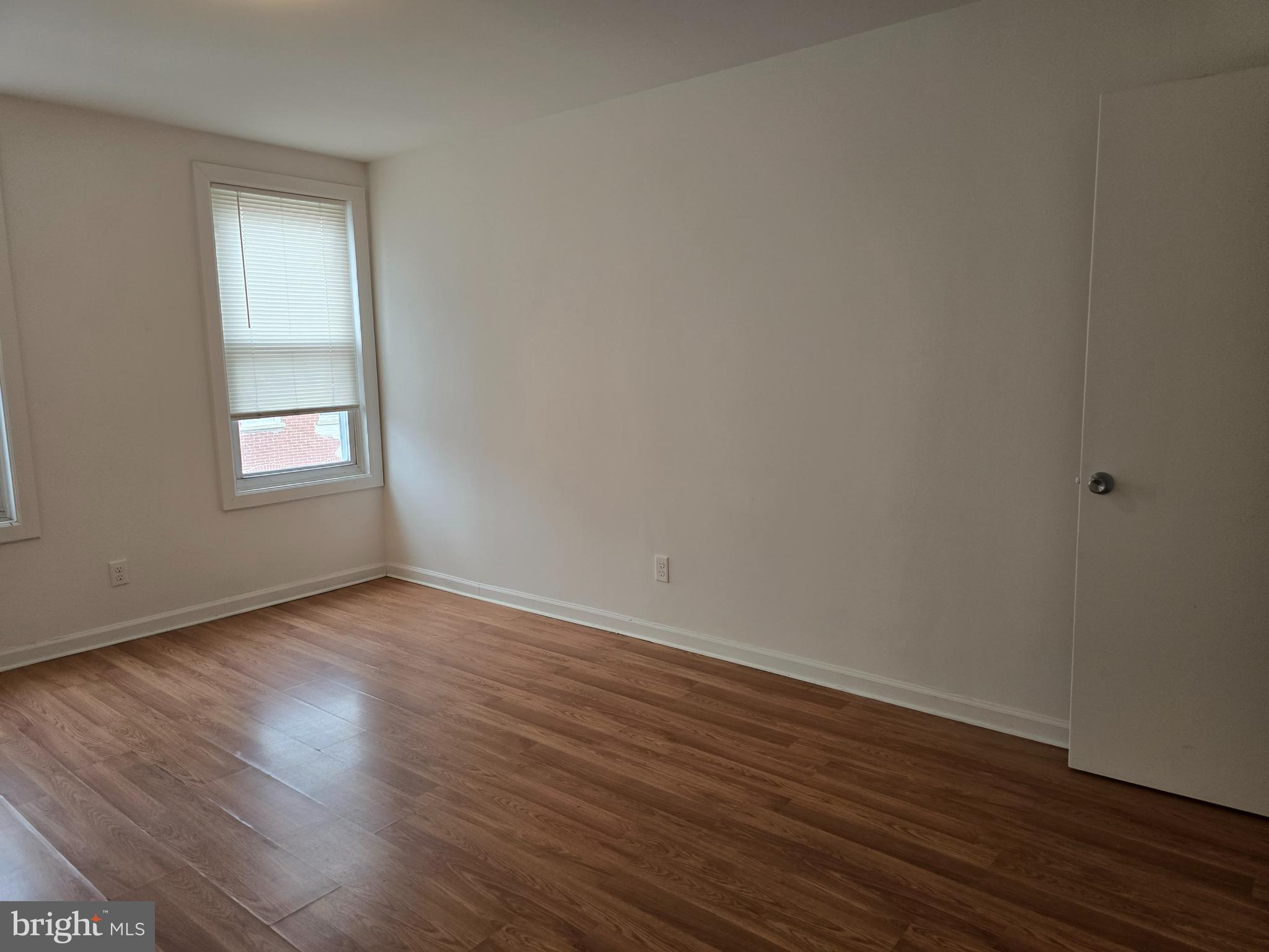 2418 Etting Street Baltimore, MD 21217 - Photo 16 of 24 a view of an empty room with wooden floor and a window
