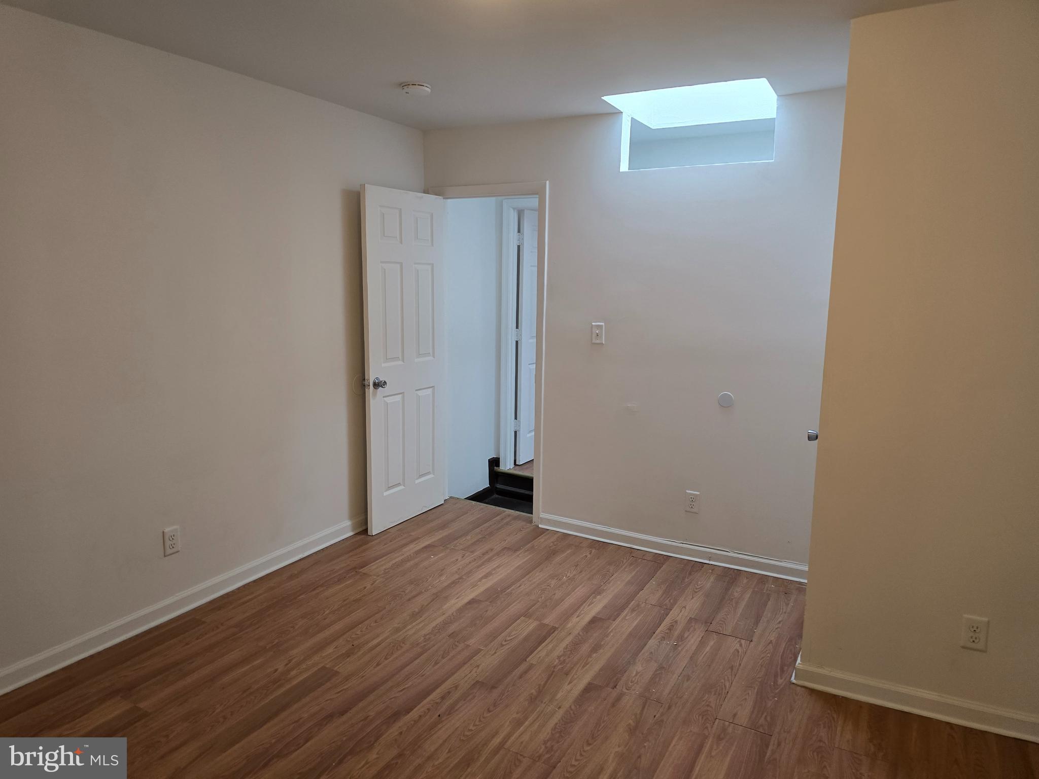2418 Etting Street Baltimore, MD 21217 - Photo 18 of 24 a view of an empty room with wooden floor