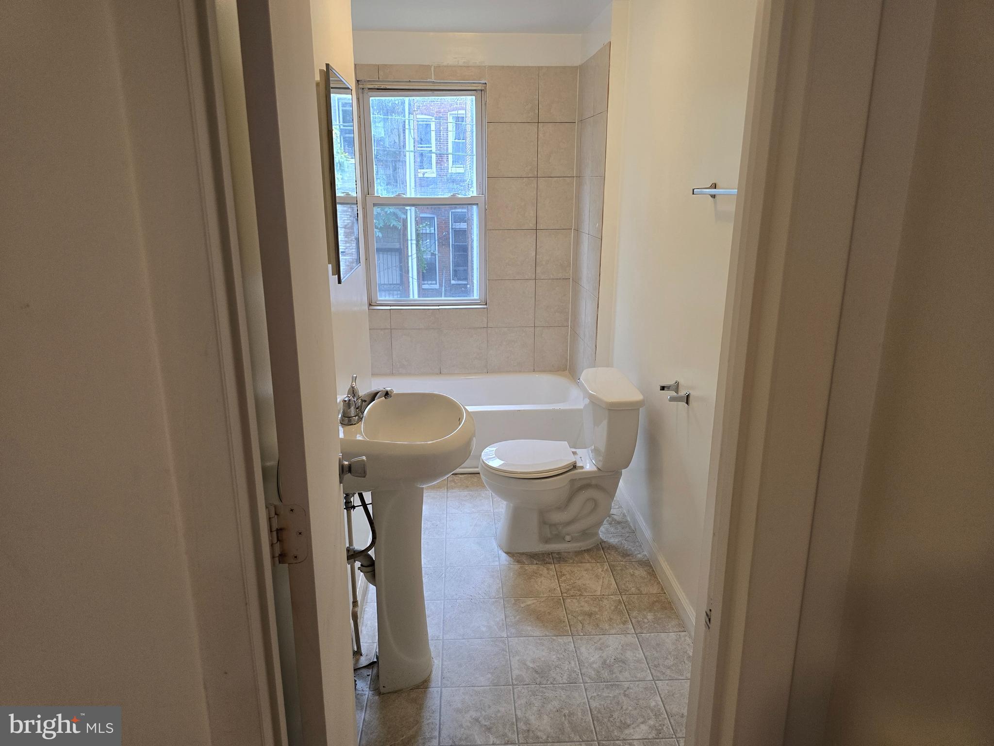 2418 Etting Street Baltimore, MD 21217 - Photo 21 of 24 a bathroom with a granite countertop toilet and a sink