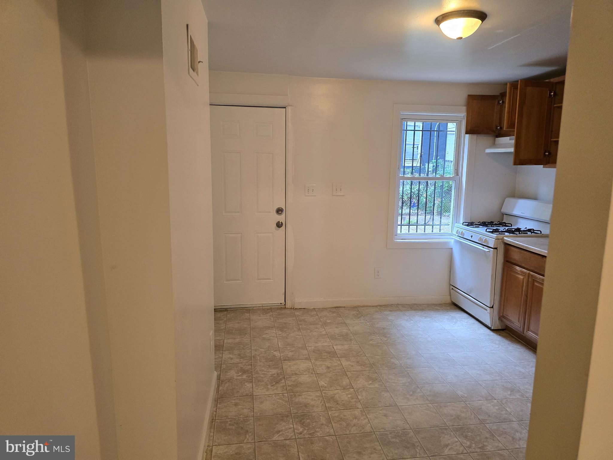 2418 Etting Street Baltimore, MD 21217 - Photo 5 of 24 a view of workspace with a window and a kitchen