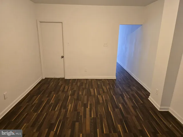a view of a room with wooden floor and staircase