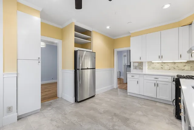 a kitchen with refrigerator cabinets and a sink