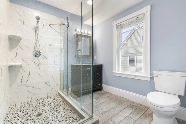 a bathroom with a toilet sink and shower