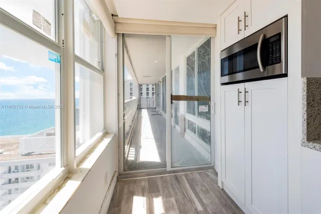 a view of a hallway with wooden floor and staircase