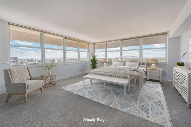 a bedroom with a bed and large windows